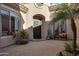 Inviting courtyard entry with a dark brown front door and brick flooring at 32029 N 19Th Ln, Phoenix, AZ 85085