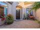 Inviting front courtyard with brick pavers and lush landscaping at 32029 N 19Th Ln, Phoenix, AZ 85085