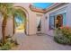 Inviting courtyard entry with brick pavers, lush landscaping, and arched walkway at 32029 N 19Th Ln, Phoenix, AZ 85085