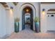 Elegant entryway with arched gate and large planters at 32029 N 19Th Ln, Phoenix, AZ 85085