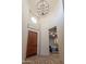 Elegant entryway with decorative tile floor, chandelier, and wood door at 32029 N 19Th Ln, Phoenix, AZ 85085