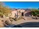 Stunning desert home with arched entry, terracotta roof, and landscaped front yard at 32029 N 19Th Ln, Phoenix, AZ 85085