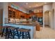 Spacious kitchen with granite island, breakfast bar, and wood cabinets at 32029 N 19Th Ln, Phoenix, AZ 85085