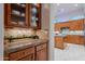 Butlers pantry with granite countertop and glass-front cabinets at 32029 N 19Th Ln, Phoenix, AZ 85085