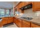 Modern kitchen with granite countertops, wood cabinets, and stainless steel appliances at 32029 N 19Th Ln, Phoenix, AZ 85085