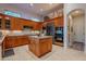 Spacious kitchen with island, stainless steel appliances, and wood cabinets at 32029 N 19Th Ln, Phoenix, AZ 85085