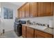 Laundry room with washer, dryer, and ample cabinet space at 32029 N 19Th Ln, Phoenix, AZ 85085