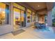 Covered patio with seating area and glass doors leading to the interior at 32029 N 19Th Ln, Phoenix, AZ 85085