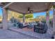 Relaxing patio seating area under a covered pergola with a ceiling fan at 32029 N 19Th Ln, Phoenix, AZ 85085