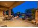 Outdoor dining area with adjacent pool and rock waterfall feature at 32029 N 19Th Ln, Phoenix, AZ 85085