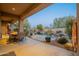 Outdoor dining area with adjacent pool and rock waterfall feature at 32029 N 19Th Ln, Phoenix, AZ 85085