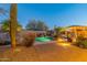 Expansive backyard oasis featuring a sparkling pool, brick patio, and desert landscaping at 32029 N 19Th Ln, Phoenix, AZ 85085