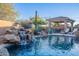 Inviting pool with a waterfall feature, pergola, and lounge chairs at 32029 N 19Th Ln, Phoenix, AZ 85085