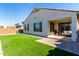 Relaxing backyard with patio, artificial grass, and string lights at 32040 N Lisadre Ln, San Tan Valley, AZ 85144