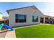 Backyard with artificial turf, patio, and play structures at 32040 N Lisadre Ln, San Tan Valley, AZ 85144