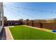 Artificial turf backyard with string lights and play area at 32040 N Lisadre Ln, San Tan Valley, AZ 85144