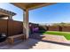 Landscaped backyard with patio, artificial turf, and play area at 32040 N Lisadre Ln, San Tan Valley, AZ 85144