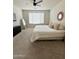Bright bedroom with carpeted floors, neutral paint, minimalist décor, and a large window for ample natural light at 32040 N Lisadre Ln, San Tan Valley, AZ 85144