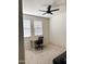 Bright bedroom with a ceiling fan, two windows, and a simple desk setup at 32040 N Lisadre Ln, San Tan Valley, AZ 85144