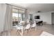 Dining area with wood table, white chairs, and access to backyard at 32040 N Lisadre Ln, San Tan Valley, AZ 85144