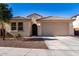 Single-story home with neutral exterior, two-car garage, and desert landscaping at 32040 N Lisadre Ln, San Tan Valley, AZ 85144