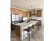 Spacious kitchen features stainless steel appliances, central island with barstool seating, and white subway tile backsplash at 32040 N Lisadre Ln, San Tan Valley, AZ 85144