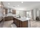 Modern kitchen with light wood cabinets, quartz island, and stainless steel appliances at 32040 N Lisadre Ln, San Tan Valley, AZ 85144