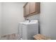 Laundry room with washer, dryer, and overhead cabinets at 32040 N Lisadre Ln, San Tan Valley, AZ 85144