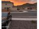 A lovely street view shows homes with desert landscaping, with a mountain backdrop and sunset sky at 32040 N Lisadre Ln, San Tan Valley, AZ 85144