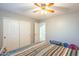 Bedroom with double door closet and ceiling fan at 3464 N Ashbrook St, Mesa, AZ 85213