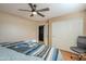 Bedroom with wood floors, ceiling fan, and access to bathroom at 3464 N Ashbrook St, Mesa, AZ 85213