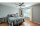 Bedroom with wood floors, ceiling fan, and window with blinds at 3464 N Ashbrook St, Mesa, AZ 85213