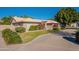 Tan house with tile roof and landscaped yard at 3464 N Ashbrook St, Mesa, AZ 85213