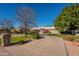 House with a long driveway and lush lawn at 3464 N Ashbrook St, Mesa, AZ 85213