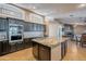 Gourmet kitchen boasts granite countertops and dark cabinetry at 3464 N Ashbrook St, Mesa, AZ 85213