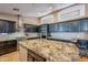 Island kitchen with granite countertops and stainless steel appliances at 3464 N Ashbrook St, Mesa, AZ 85213