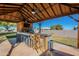 Covered outdoor kitchen with bar seating, grill, and TV at 3464 N Ashbrook St, Mesa, AZ 85213