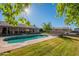 Inviting kidney-shaped pool with patio and covered seating area at 3464 N Ashbrook St, Mesa, AZ 85213