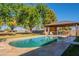 Relaxing oval pool with a large covered patio and bar area at 3464 N Ashbrook St, Mesa, AZ 85213