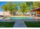 Stunning oval pool, patio, and walkway near a large covered patio at 3464 N Ashbrook St, Mesa, AZ 85213