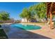 Inviting kidney shaped pool with patio and covered seating at 3464 N Ashbrook St, Mesa, AZ 85213