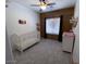 Charming Bedroom with crib, changing table, and wood accent wall at 35801 N Zachary Rd, San Tan Valley, AZ 85144