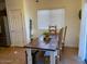 Bright dining area features a rustic wooden table with seating for four at 35801 N Zachary Rd, San Tan Valley, AZ 85144