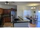 Kitchen with breakfast bar, granite counters, and a farmhouse table at 35801 N Zachary Rd, San Tan Valley, AZ 85144