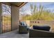 Cozy outdoor balcony with comfortable seating and neutral wall featuring decorative brick accents at 39493 N 107Th Way, Scottsdale, AZ 85262