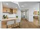 Wet bar with custom cabinetry, wine storage, and seating overlooking the living spaces at 39493 N 107Th Way, Scottsdale, AZ 85262