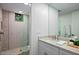 Modern bathroom features a walk-in shower with herringbone tile, a large mirror, and sleek vanity at 39493 N 107Th Way, Scottsdale, AZ 85262