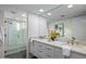 Elegant bathroom with double sinks, a marble countertop, and a glass-enclosed shower at 39493 N 107Th Way, Scottsdale, AZ 85262