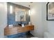 Stylish bathroom with wood floating vanity, vessel sink, modern fixtures, and decorative mirror at 39493 N 107Th Way, Scottsdale, AZ 85262