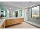 Bright bathroom boasts double vanity with modern cabinetry and a glass-enclosed shower with bronze hardware at 39493 N 107Th Way, Scottsdale, AZ 85262